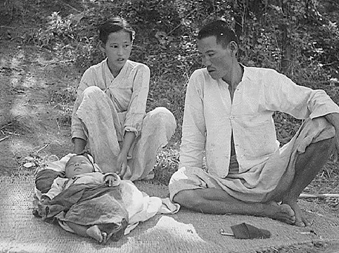 Image of A refugee family from Ching Pung Men near Masan, who lived in a refugee camp at Changseung-po, Korea. United Nations. October 1950. *National Archives