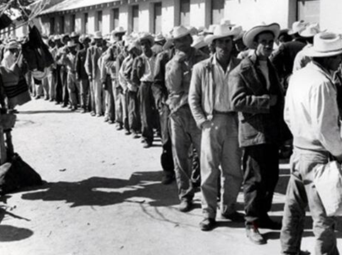 Image of Braceros waiting in line for processing at the Rio Vista Reception Center, El Paso, Texas.
