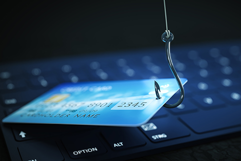 Credit Card on a fishing hook over a computer keyboard