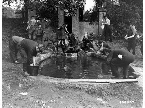 Image of Jewish Displaced Persons wash up in a pool at a displaced persons camp near Hagenow, Germany, May 30, 1945. *United States Holocaust Memorial Museum, courtesy of National Archives and Records Administration, College Park.