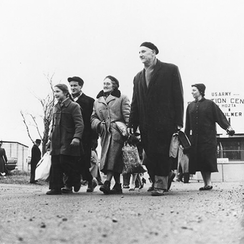 Image of  A group of Hungarian refugees leaving the Camp Kilmer Reception Center in New Jersey in 1956. Courtesy of the USCIS History Library